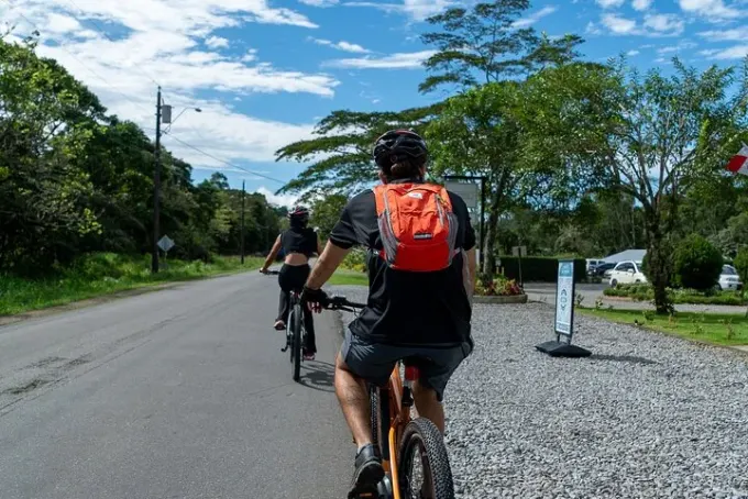 Travelers riding E-Valley e-bikes on a road near Boquete