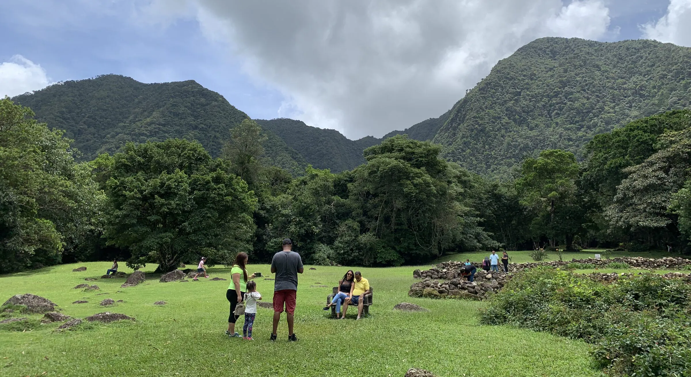 Families on the grass below the forested crater walls that ring El Valle de Antón